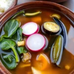 Traditional Filipino Sinigang soup with vegetables in tamarind broth.