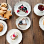 A rustic table showcasing a variety of sourdough desserts, including cookies, cakes, and cinnamon rolls.